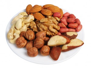 Set of nuts on a white plate, isolated